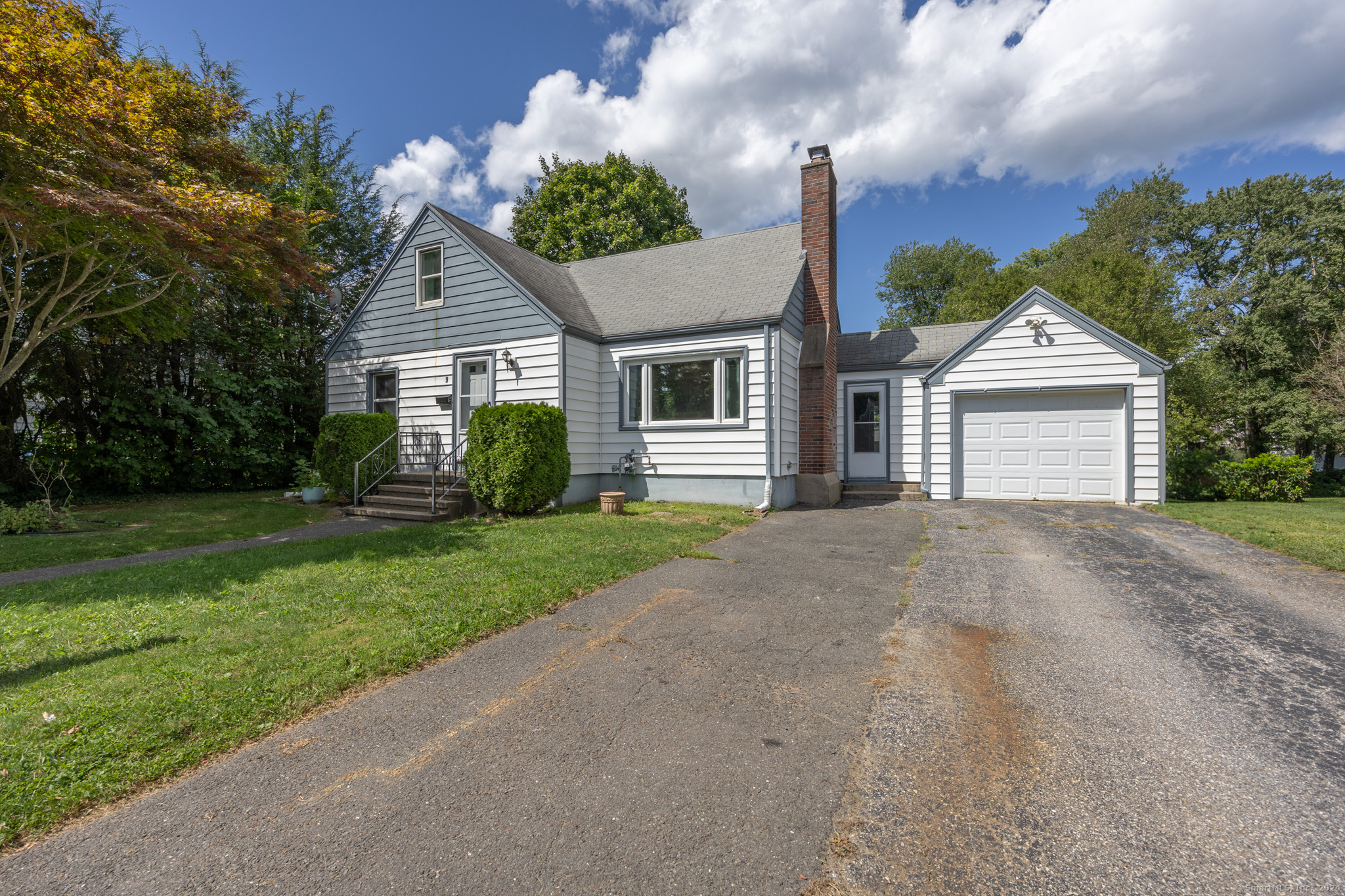 a front view of house with yard and green space