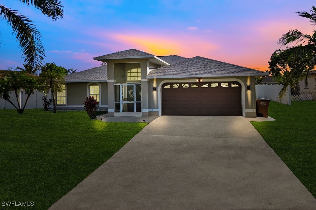 a front view of a house with a yard and garage