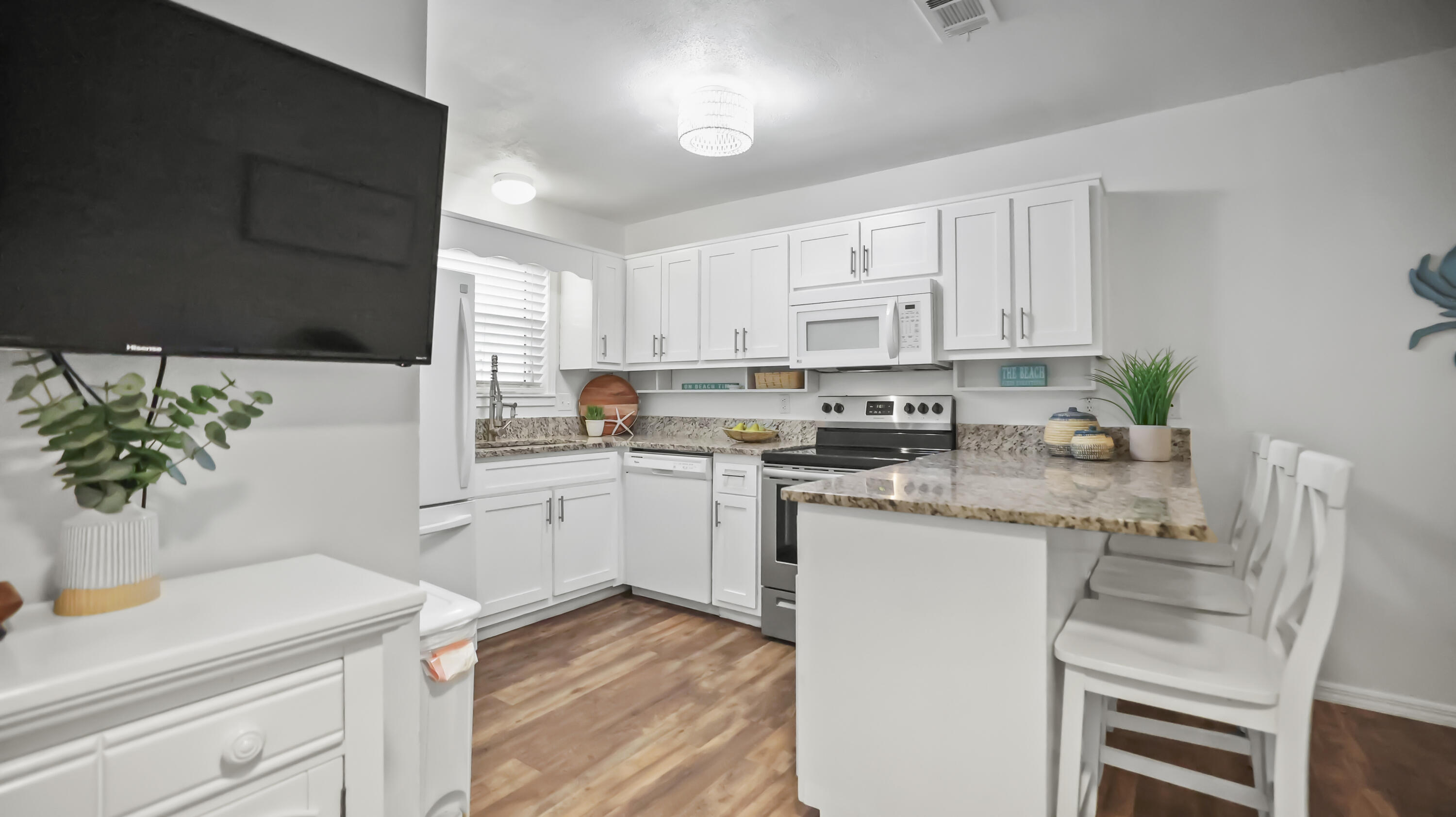 a kitchen with appliances a sink and cabinets