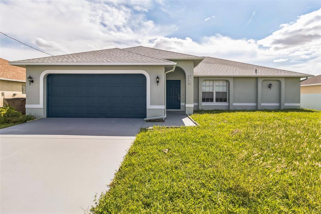 a front view of a house with a yard and garage