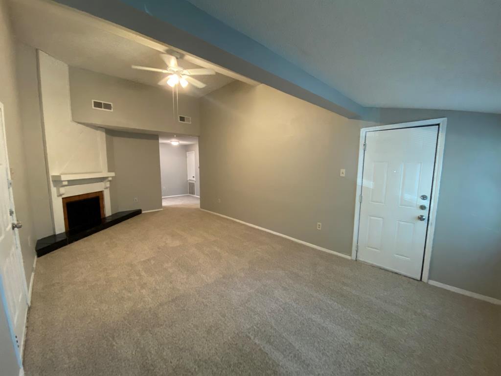 a view of empty room with a fireplace