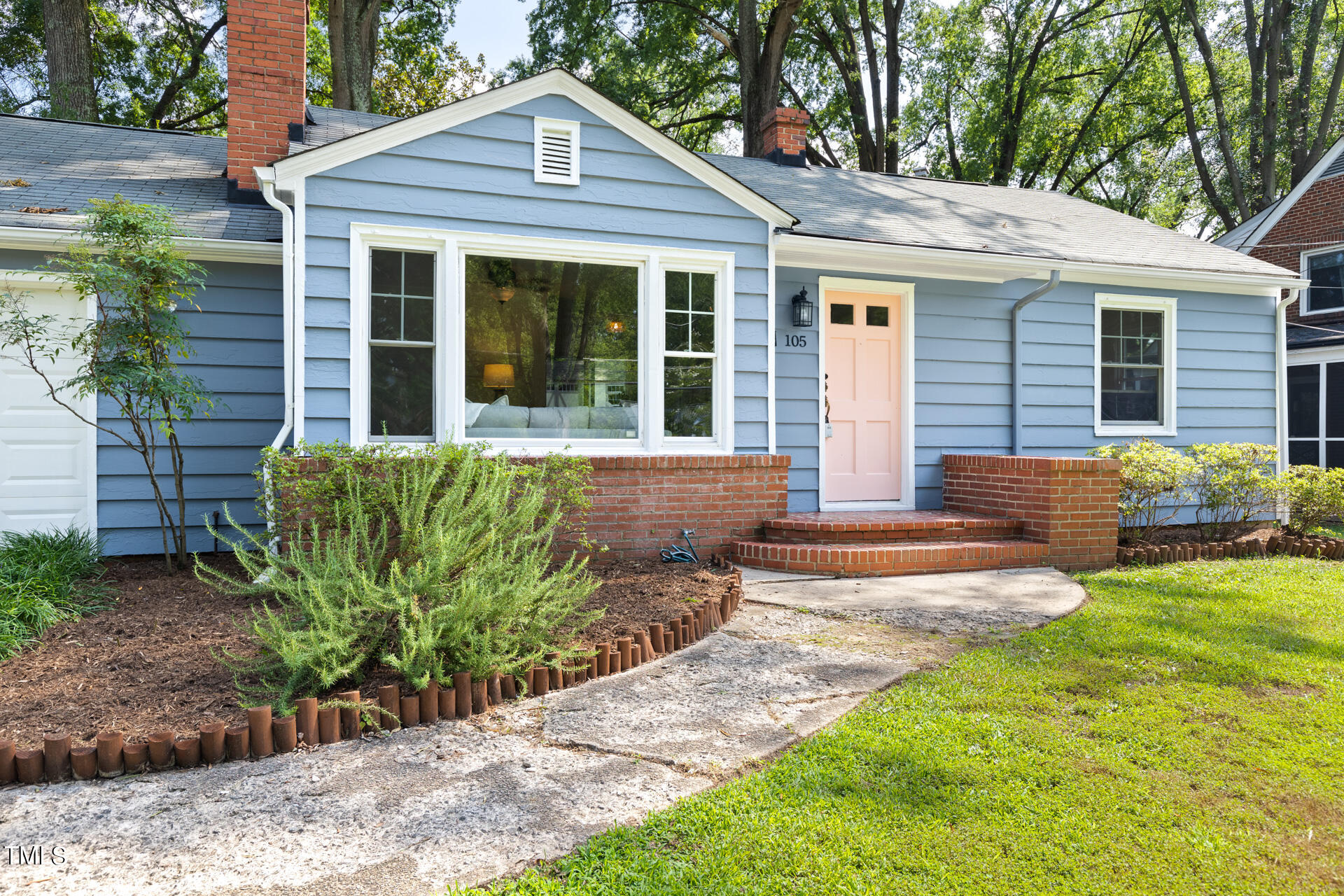 a front view of a house with garden