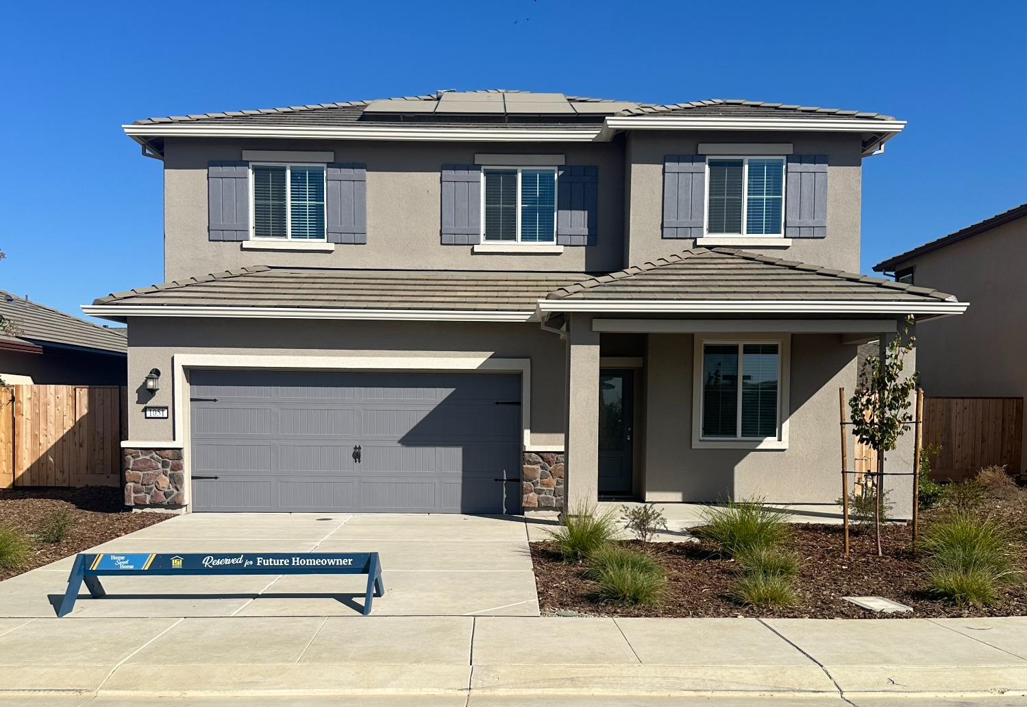 a front view of a house with garage