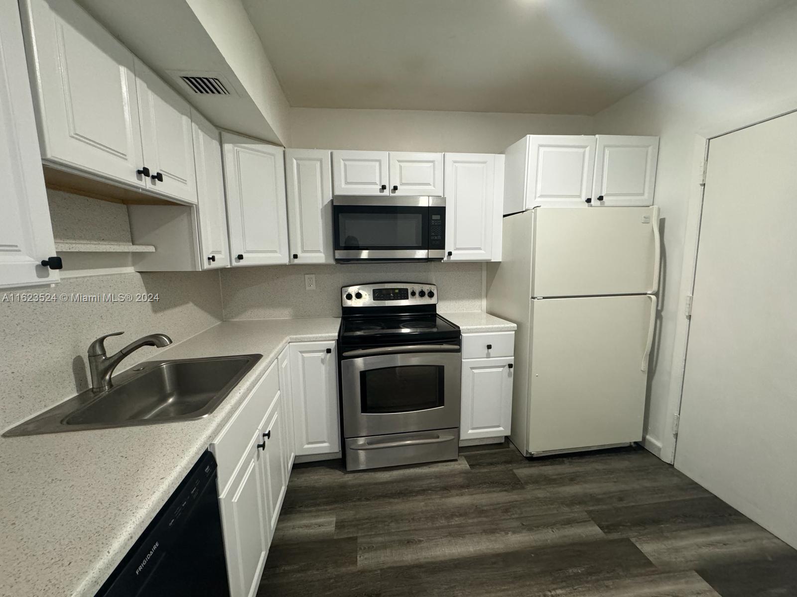 a kitchen with a refrigerator stove and sink