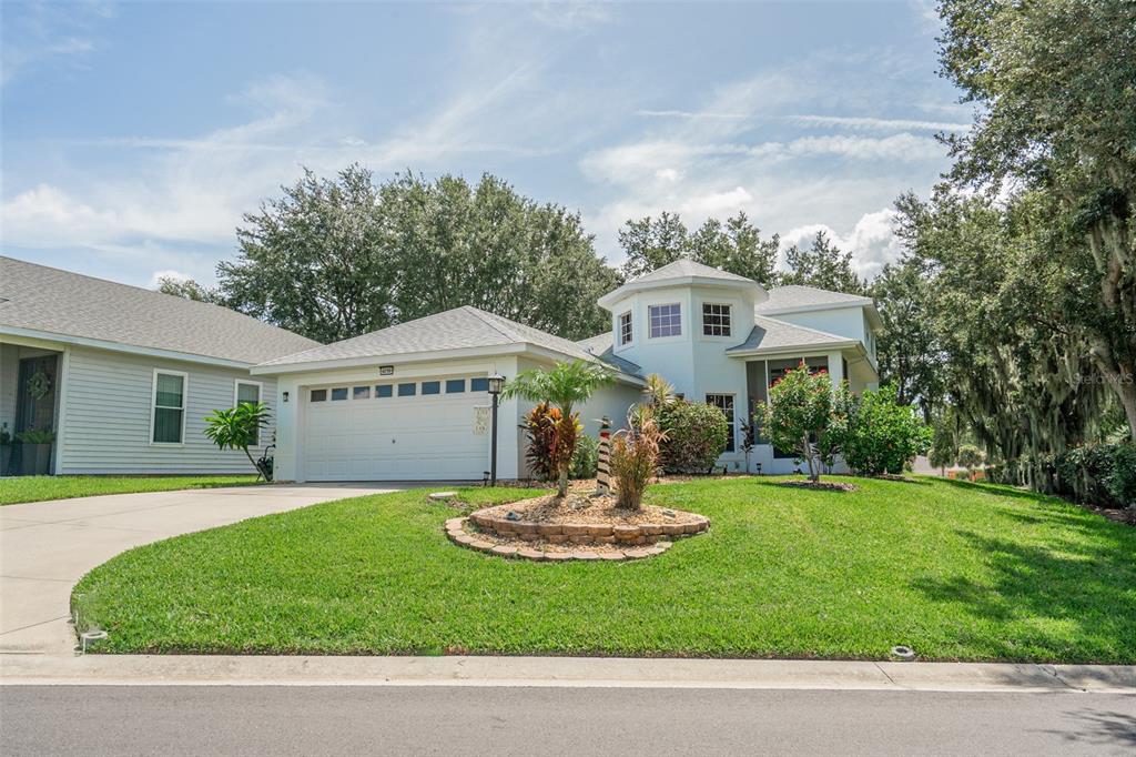 a front view of a house with a yard and garage