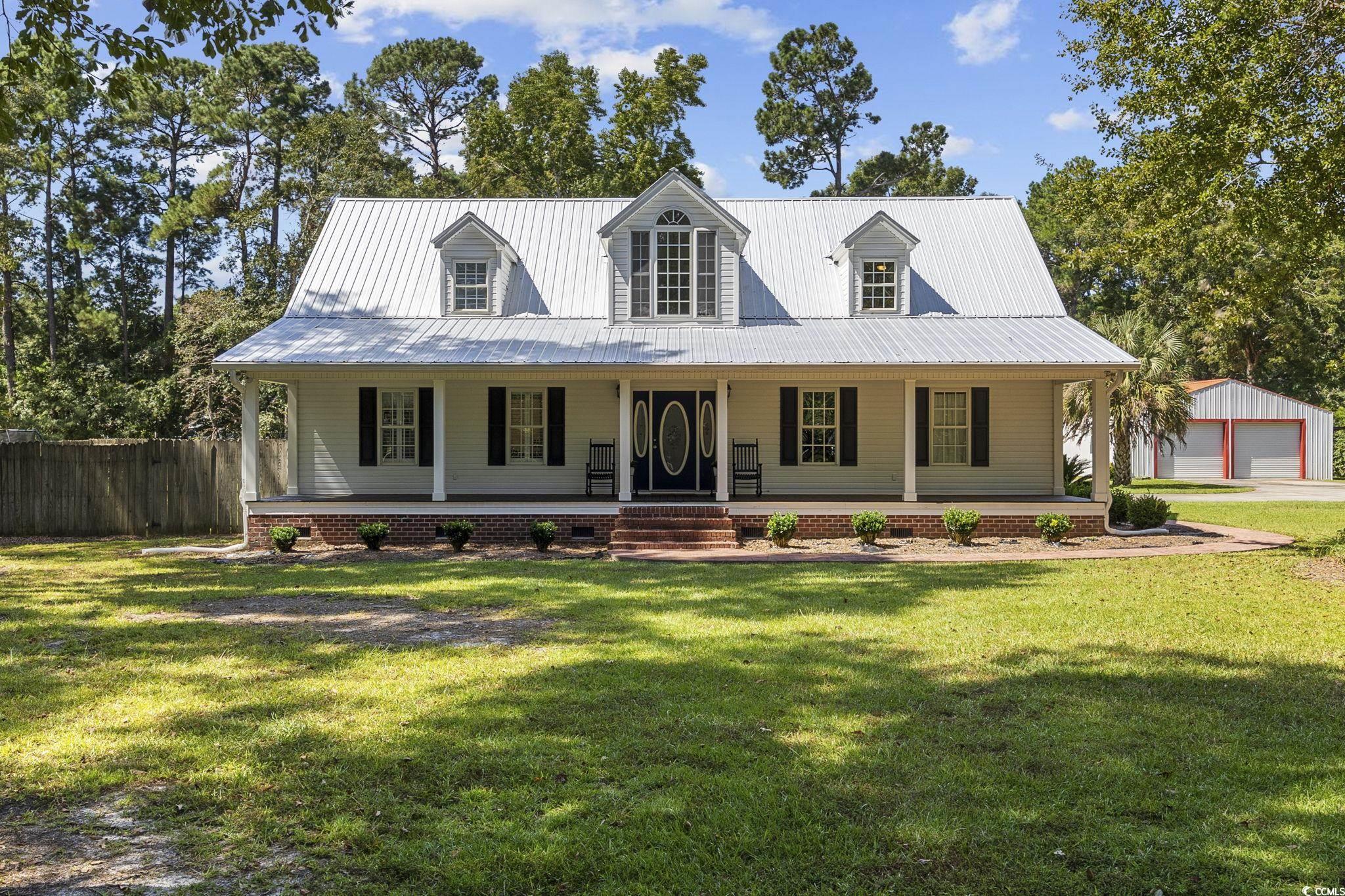 View of front of property featuring a garage, a fr