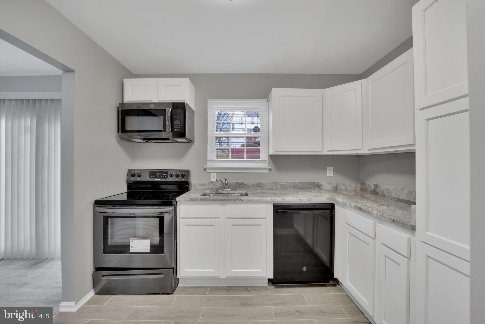 a kitchen with a stove and a microwave