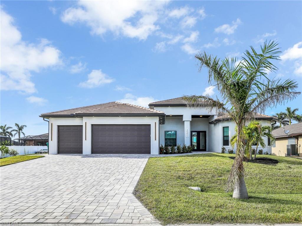 View of front facade with a garage and a front yard