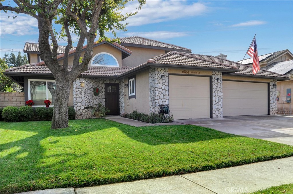 a front view of a house with a yard and garage