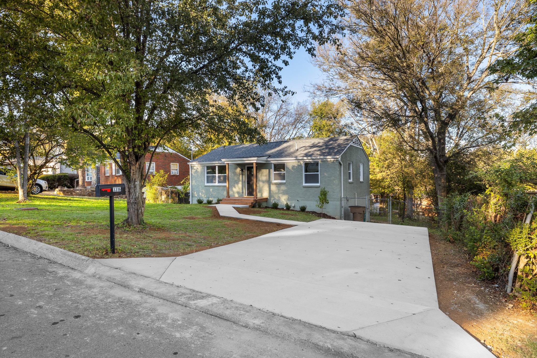 a front view of house with yard and green space