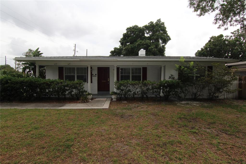 a front view of house with yard and green space