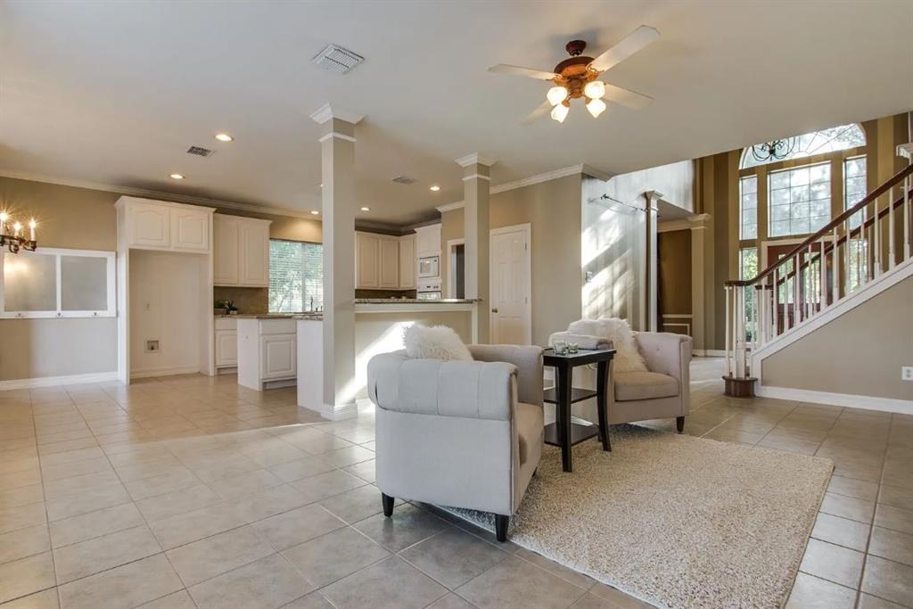 a living room with furniture and kitchen view