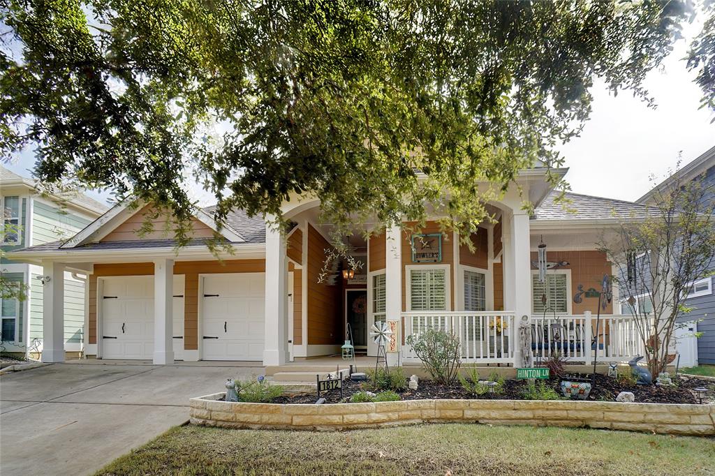 front view of a house with a tree in front of it