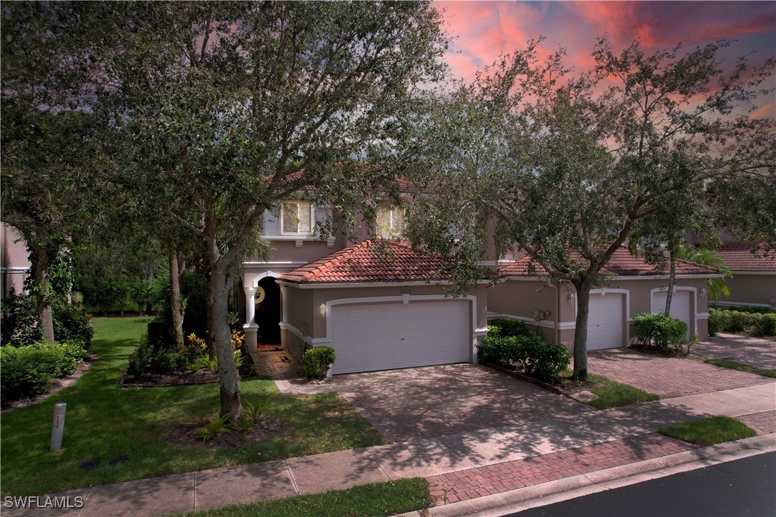 a view of a house with a yard and tree s