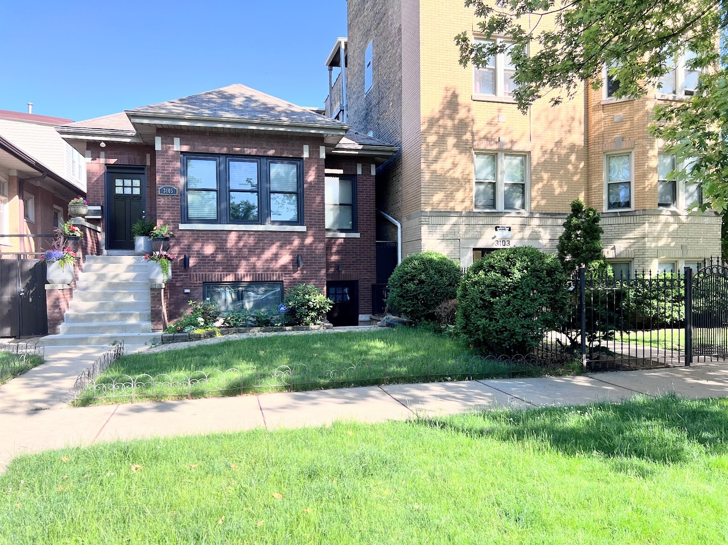 a front view of a house with a yard and a fountain