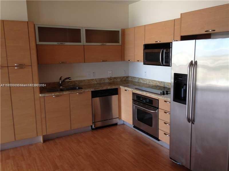 a kitchen with a sink and a microwave