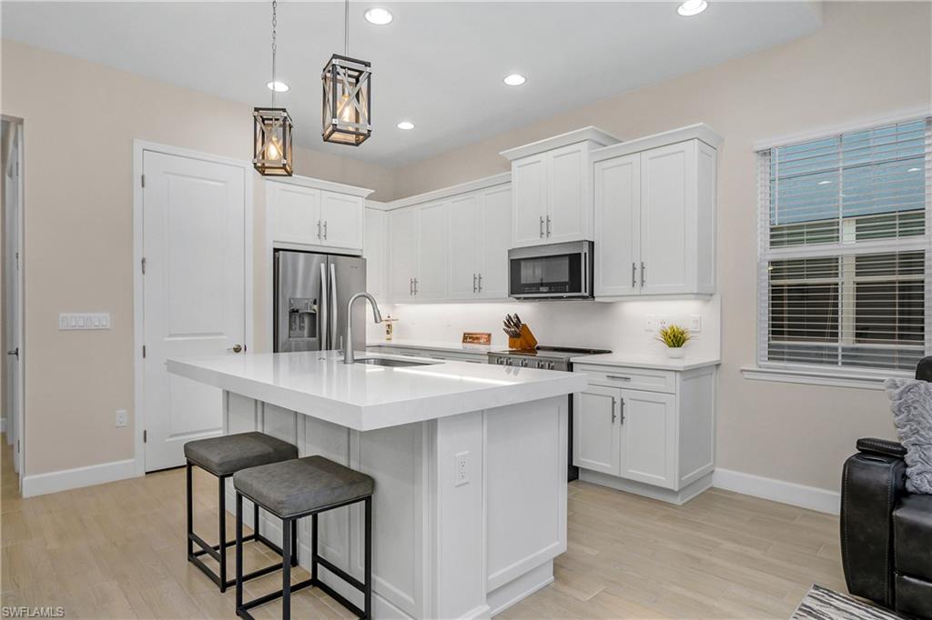 a kitchen with stainless steel appliances a sink and stove