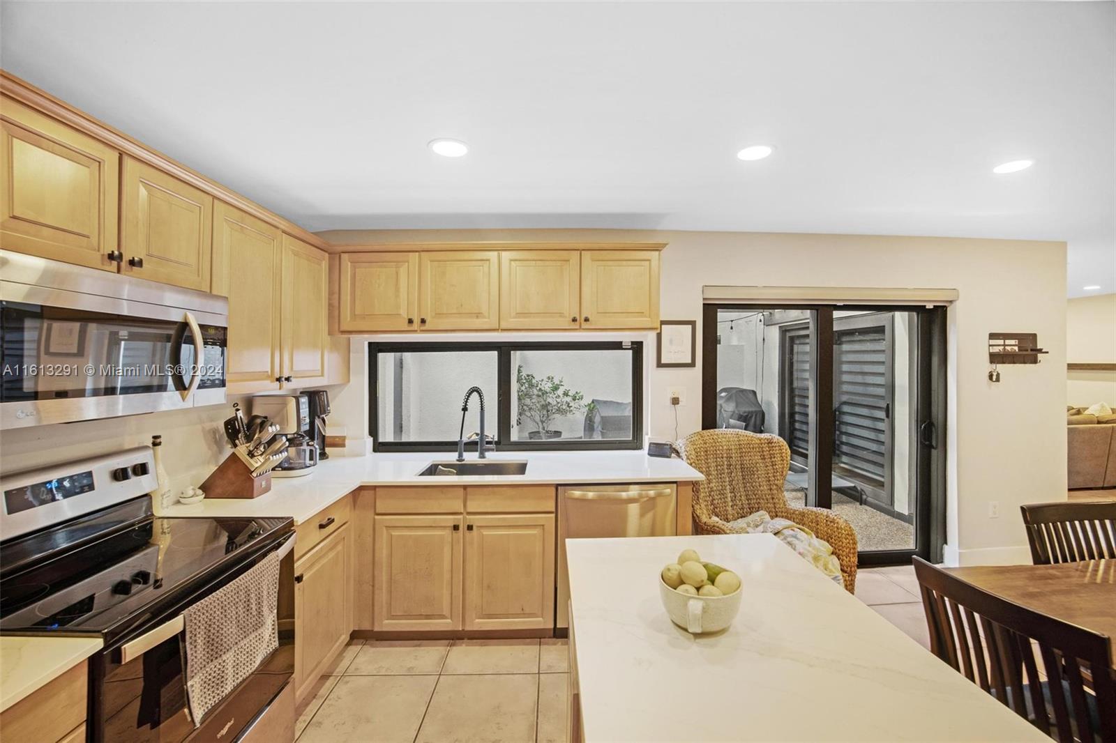 a kitchen with stainless steel appliances granite countertop a stove sink and cabinets