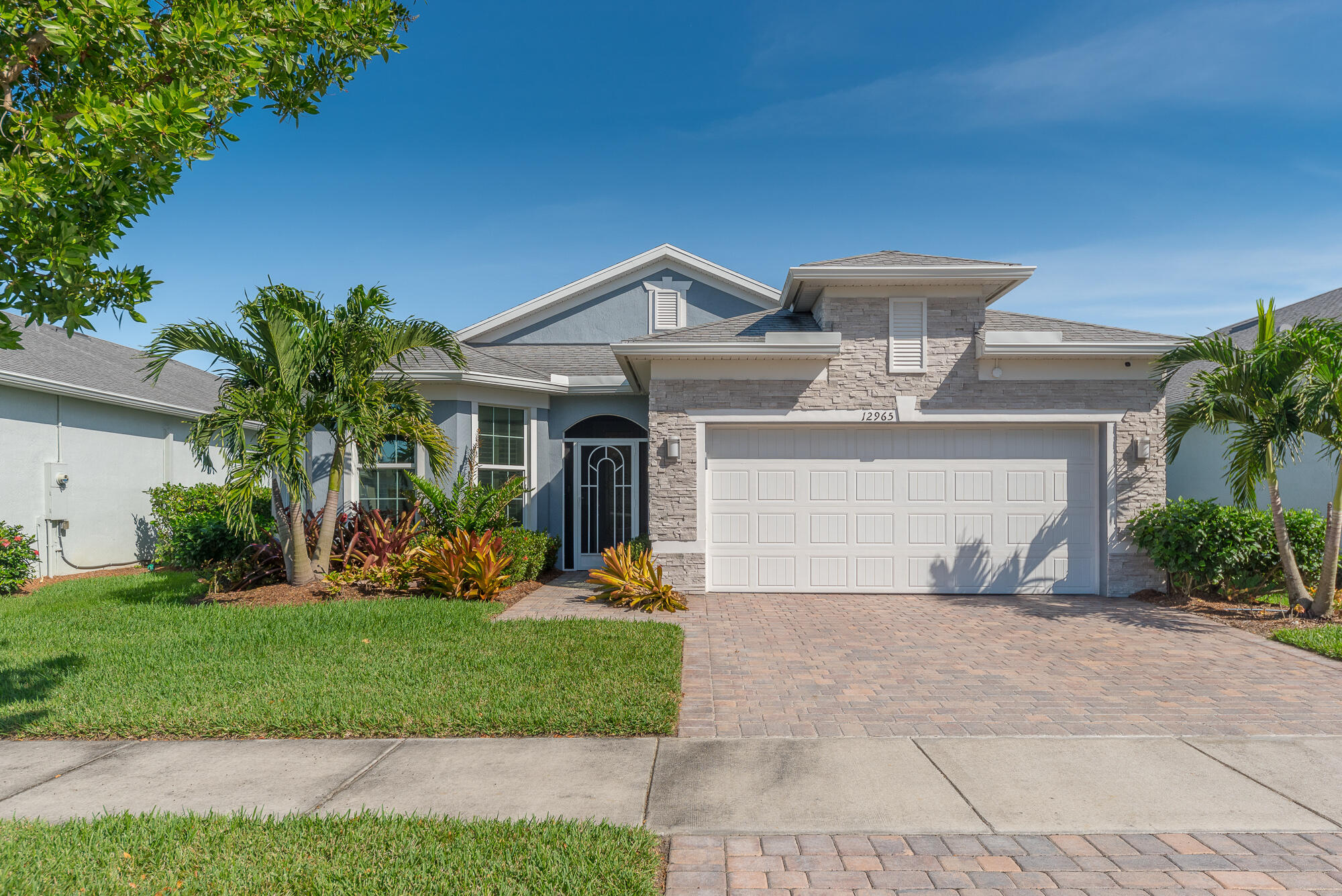 a front view of a house with a yard garage and outdoor seating