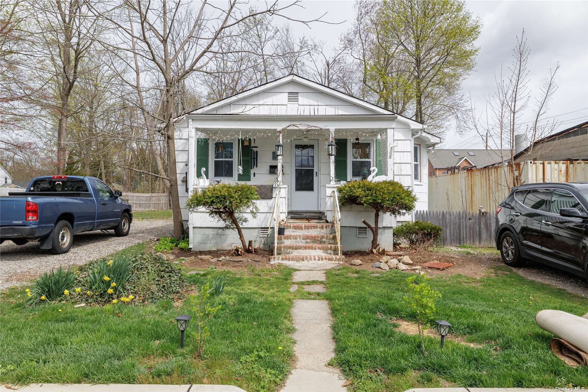 a view of a house with furniture and a yard