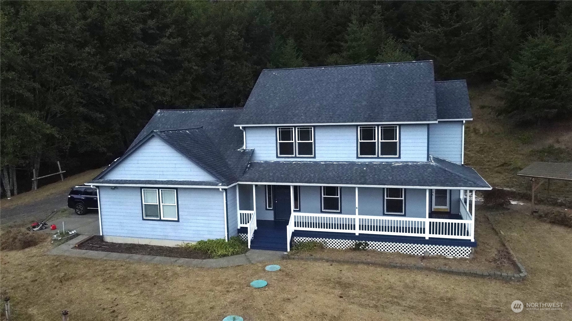 a house that has a large tree in front of it