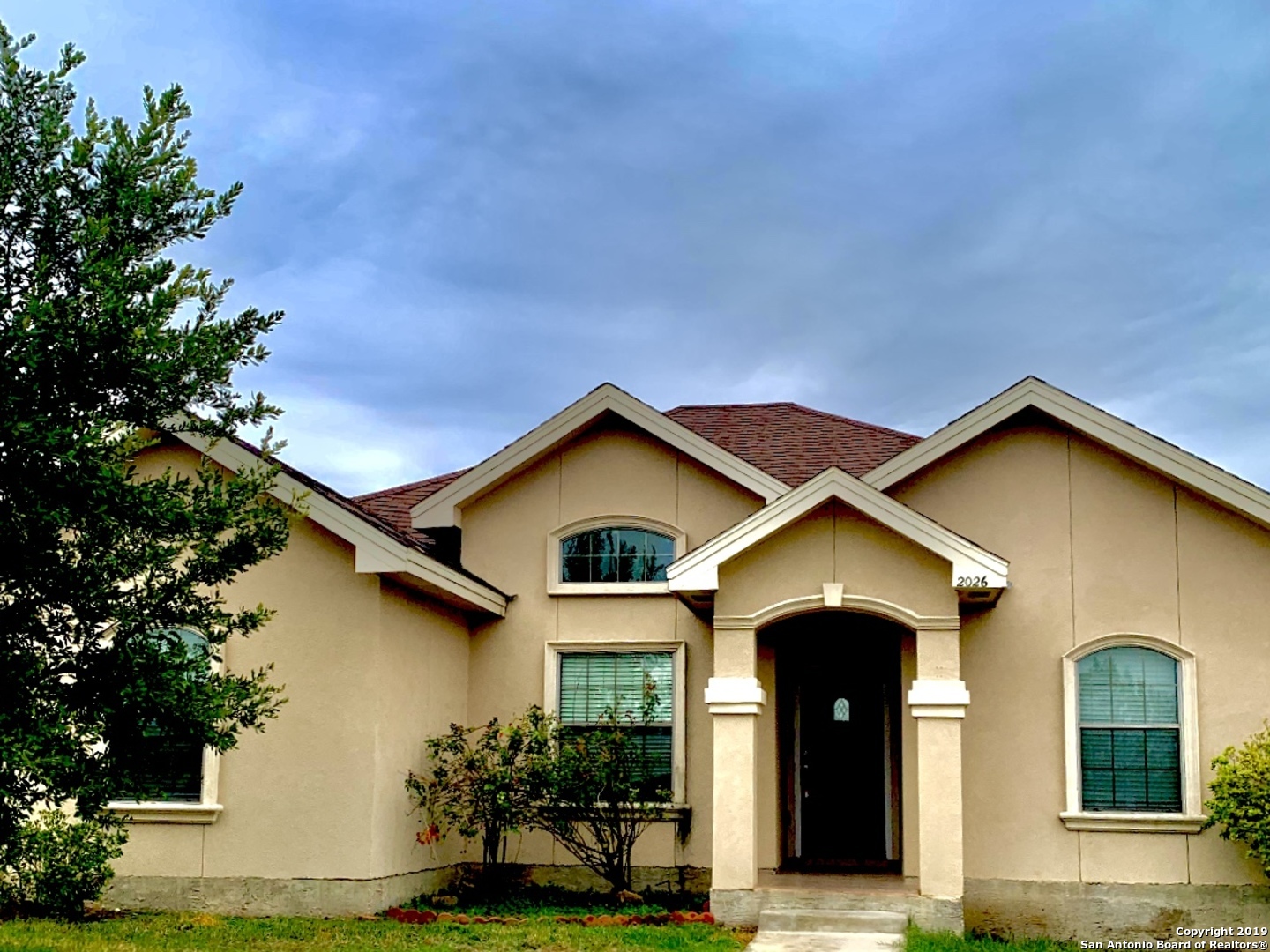 a front view of a house with a yard