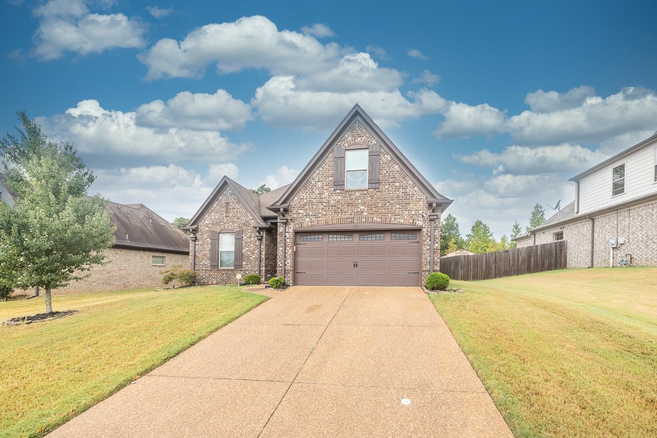 Tudor-style house with a garage and a front lawn