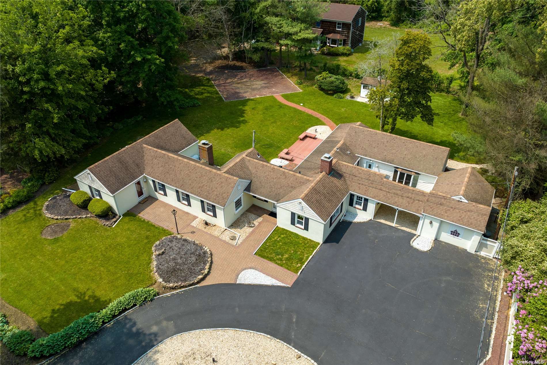 an aerial view of a house with garden space and street view