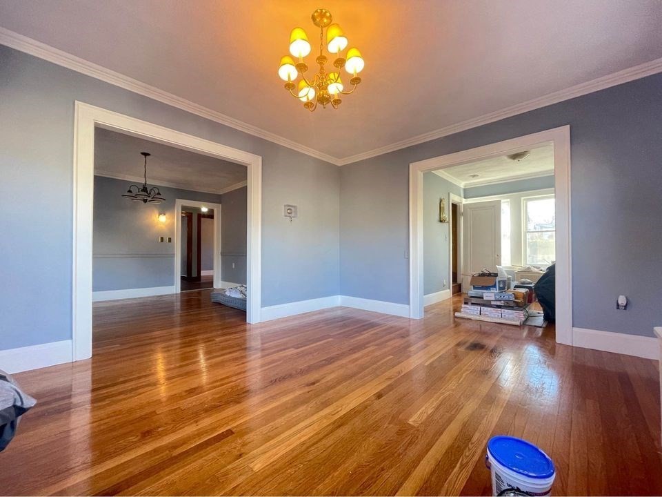 a view of empty room with wooden floor