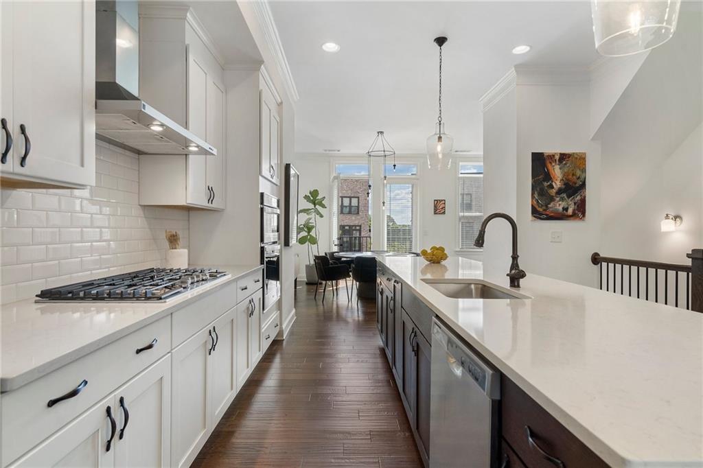 a kitchen with stainless steel appliances a sink stove and cabinets