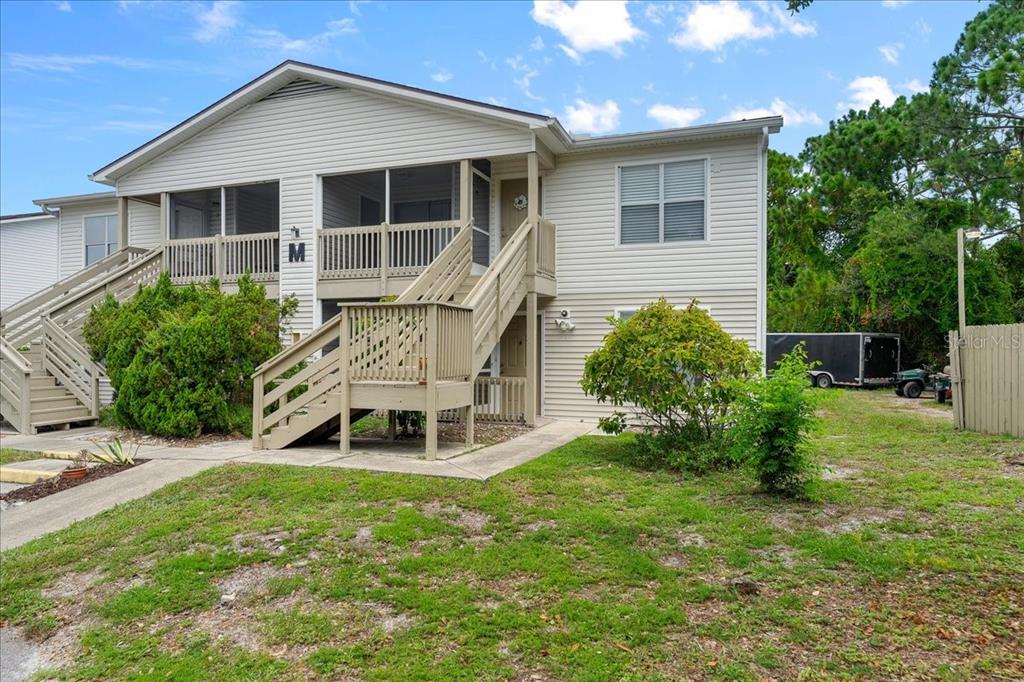 a front view of a house with a yard and outdoor seating