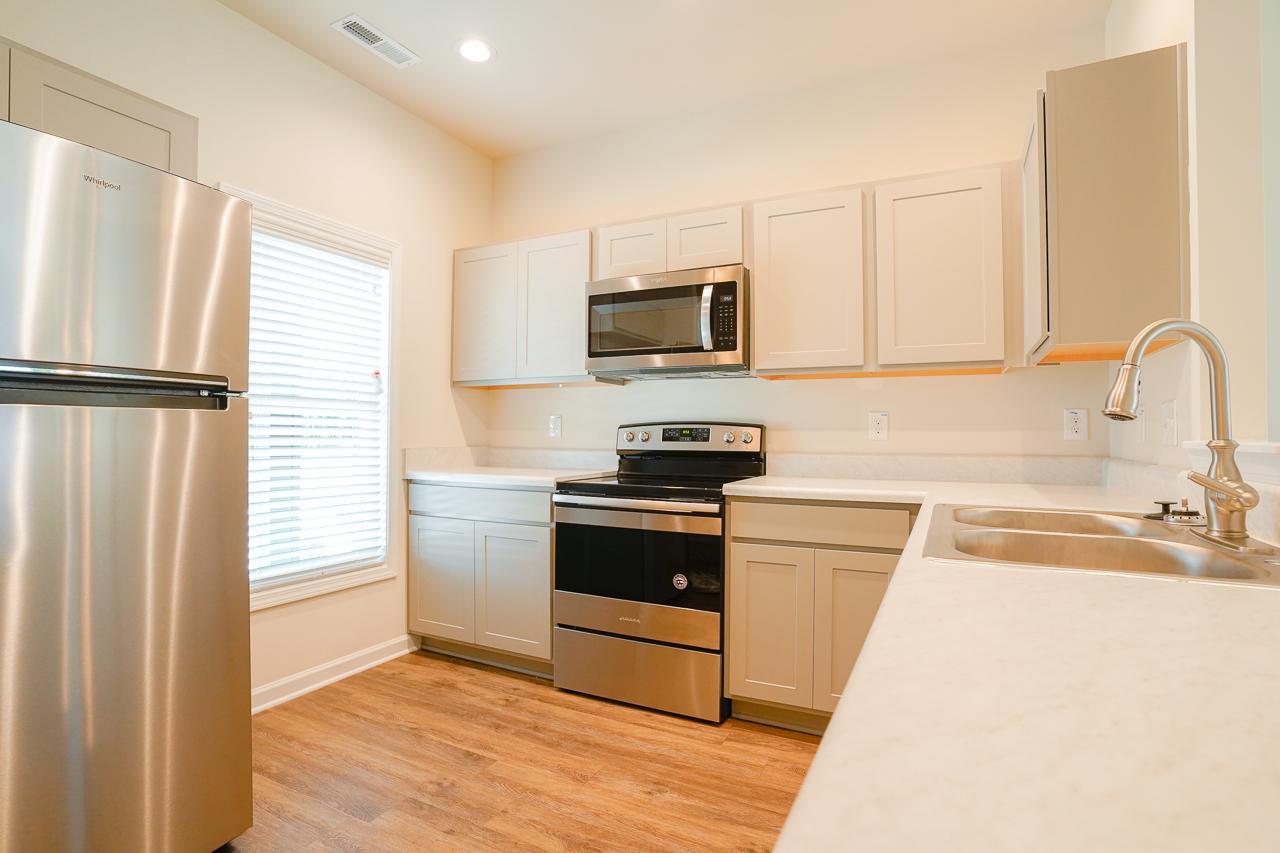 a kitchen with a refrigerator stove and sink