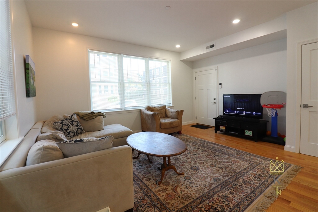 a living room with furniture a rug and a window