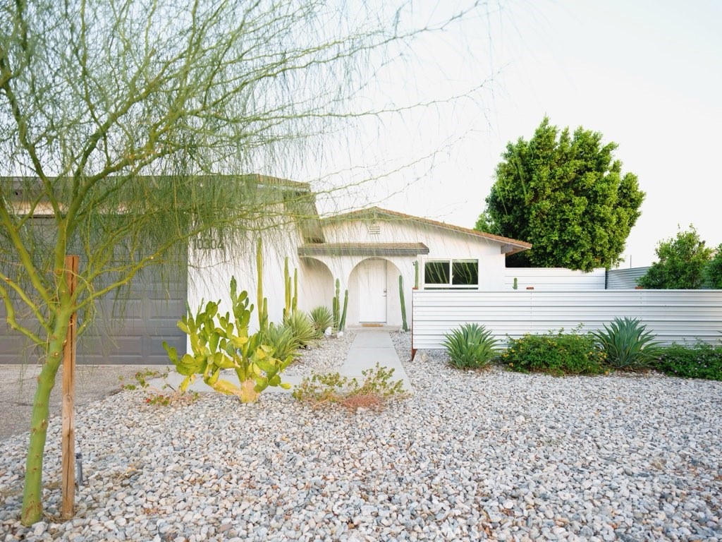 a front view of a house with garden