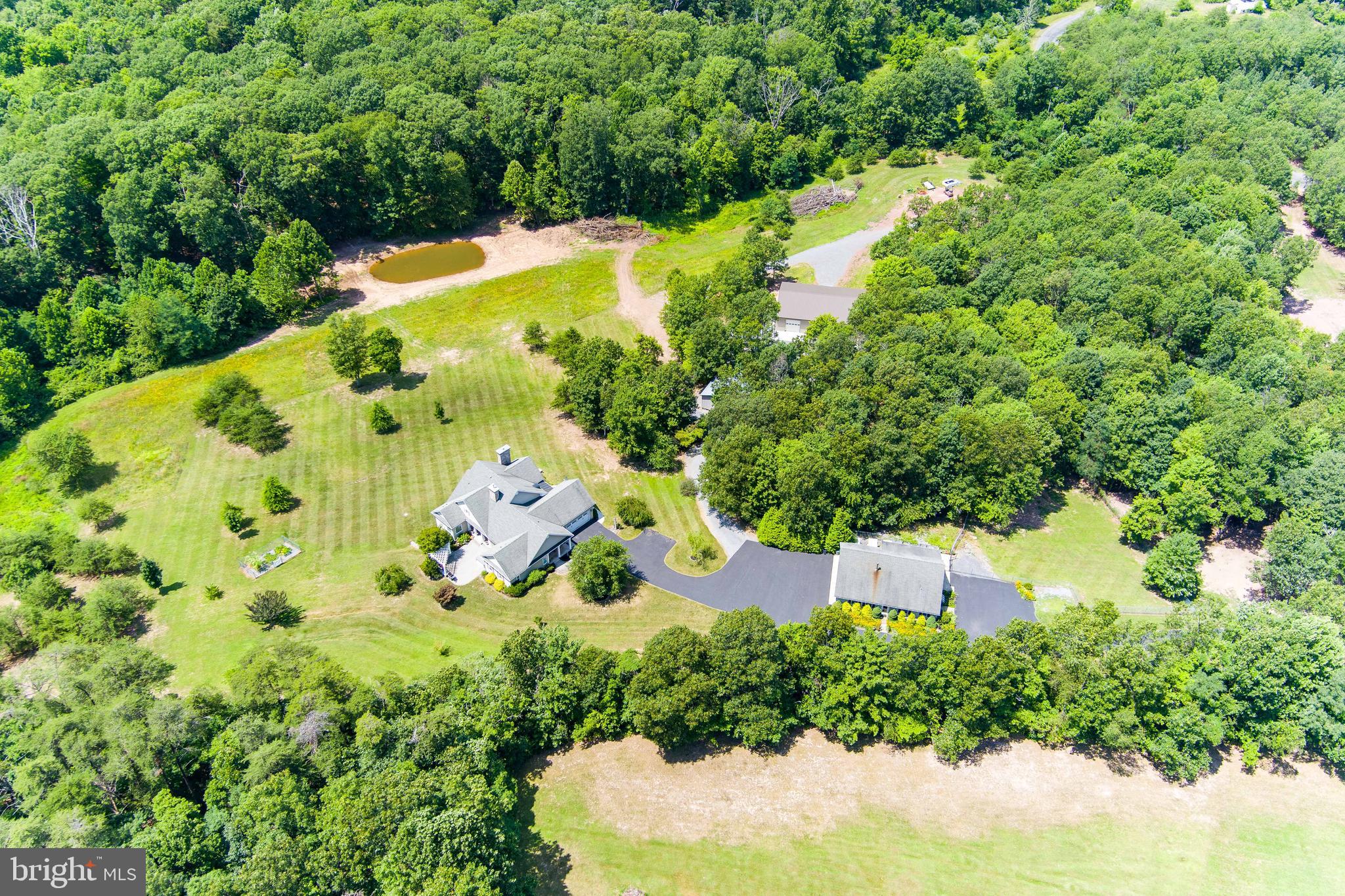 an aerial view of a house with yard