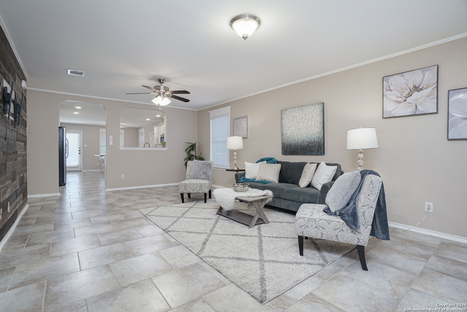 a living room with furniture and a mirror