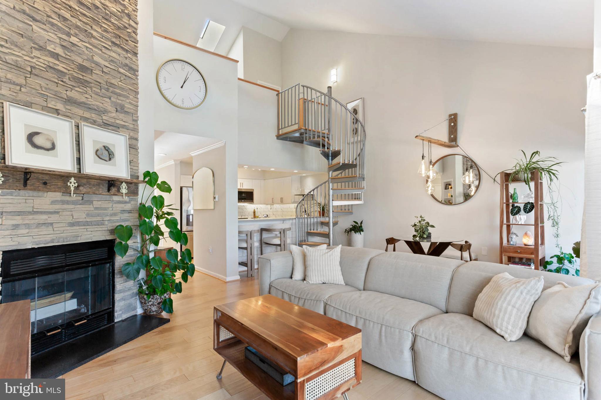 a living room with furniture a clock and a fireplace