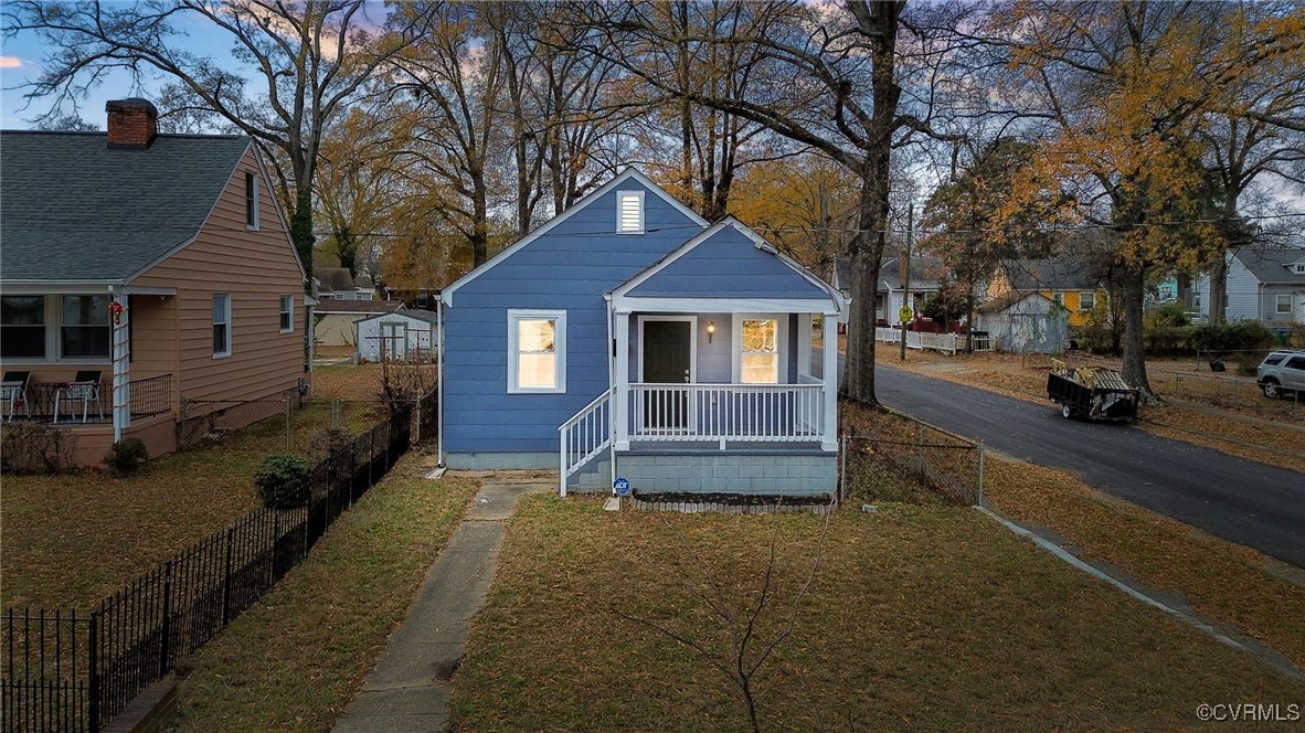 Bungalow-style house with a lawn