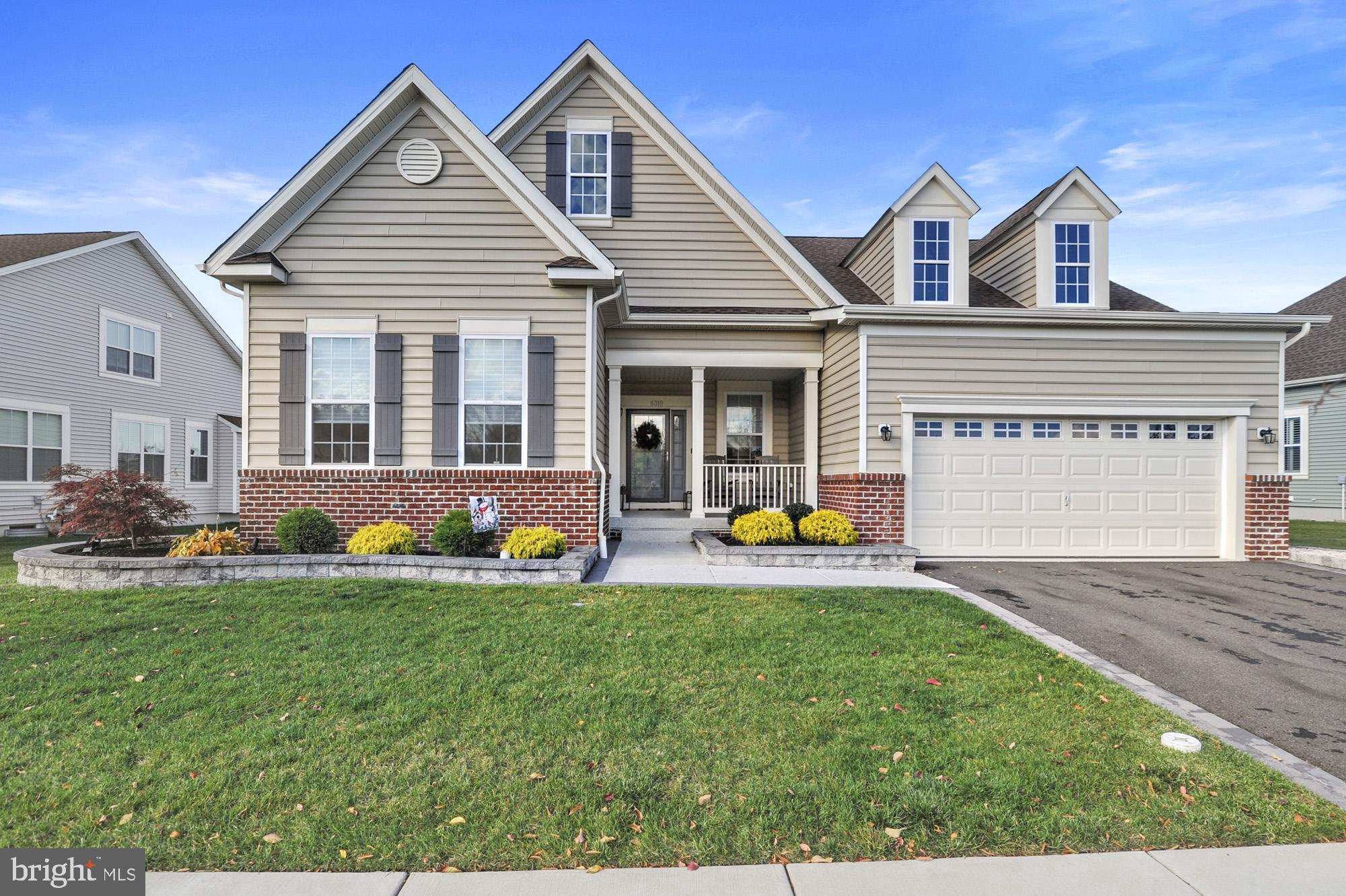 a view of a house with patio and a yard