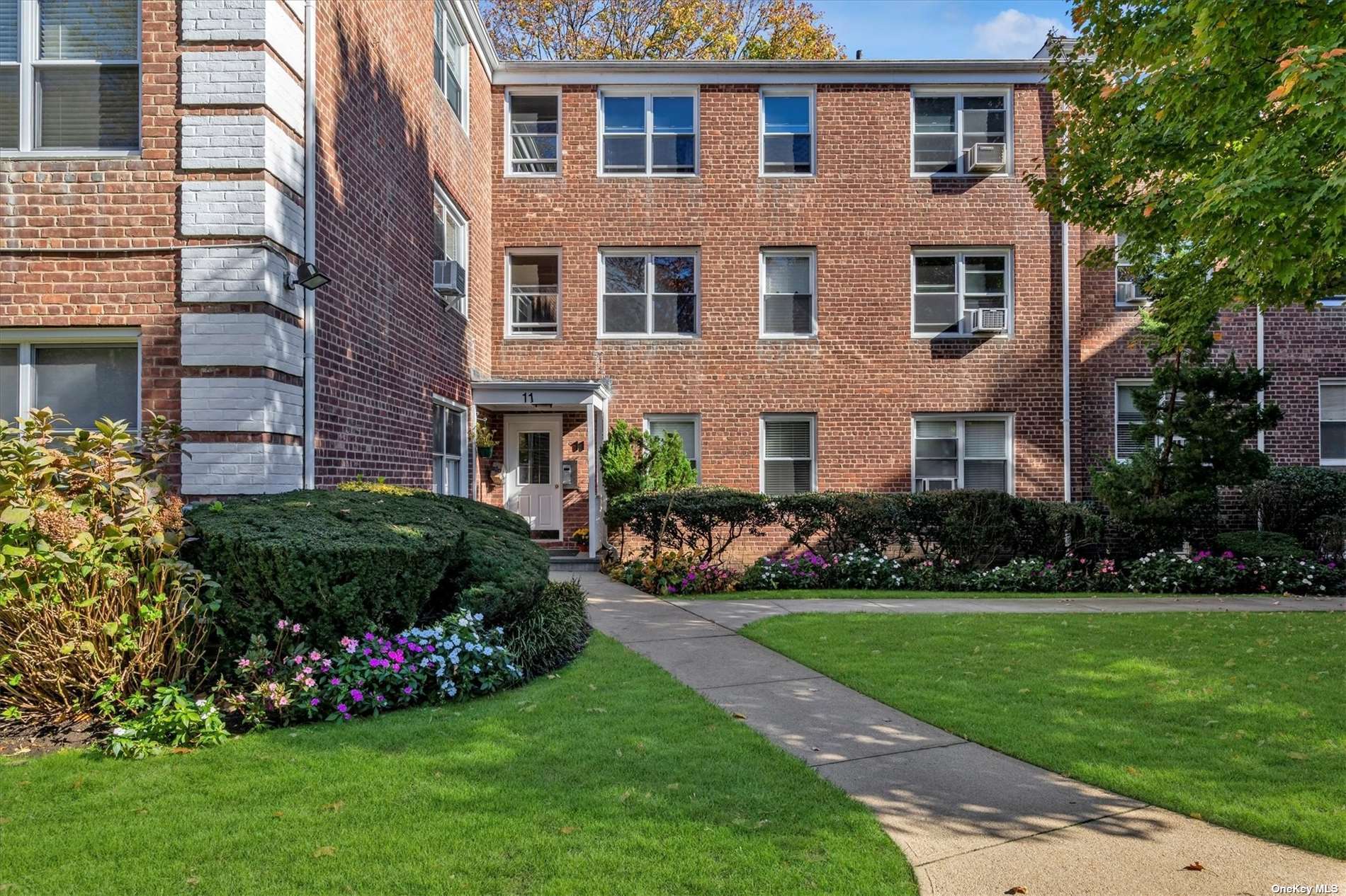 a view of a brick building next to a yard