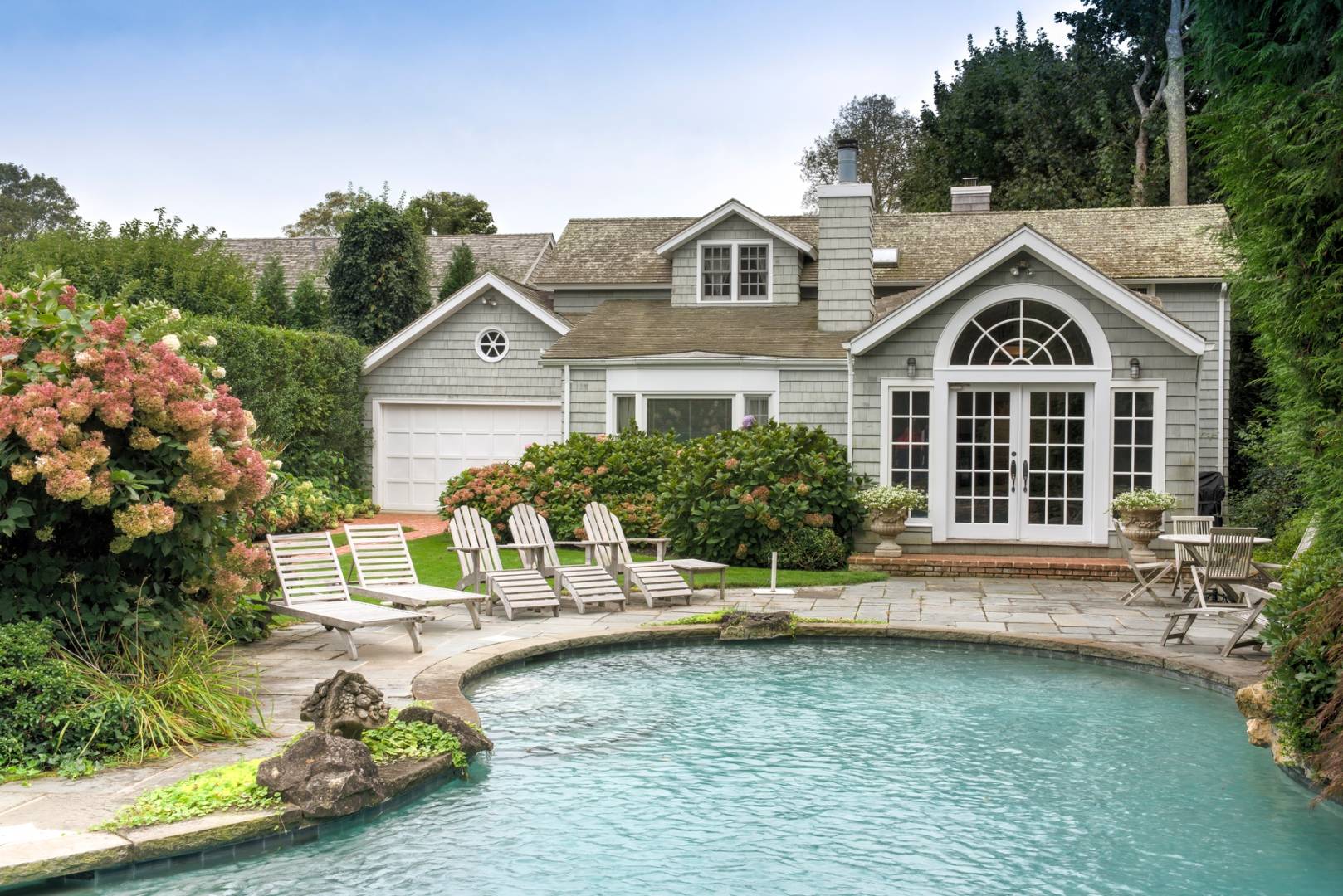 a front view of a house with a garden