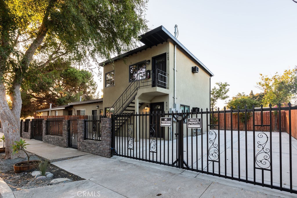 a view of a house with wooden fence