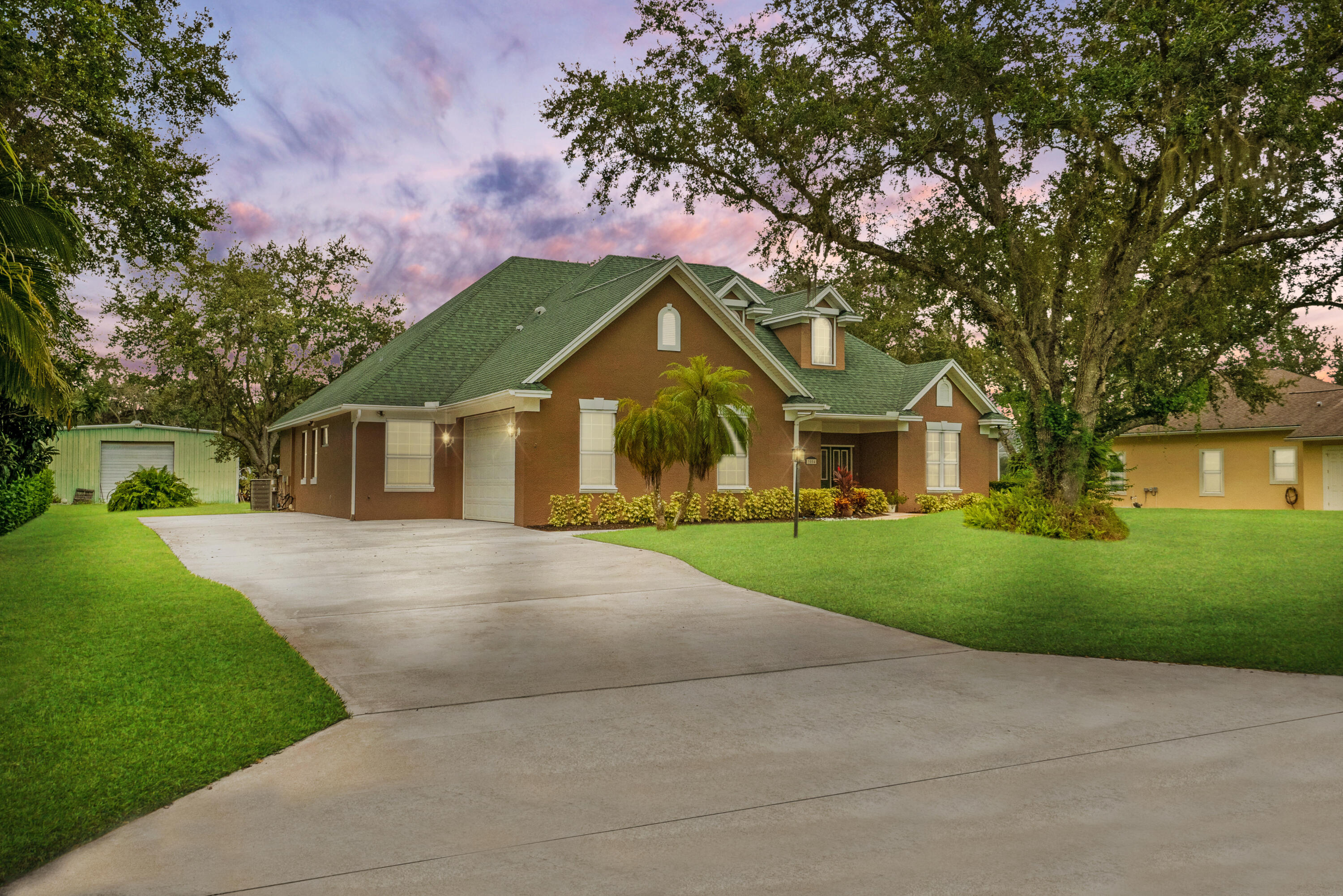 a front view of a house with a yard and garage