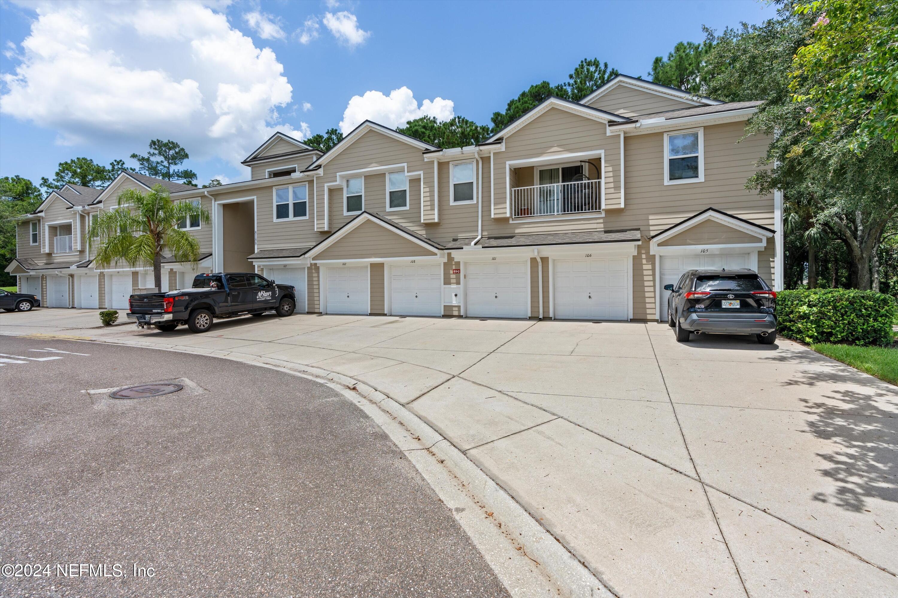 a front view of a house with a parking space