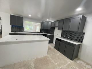 a kitchen with sink cabinets and window