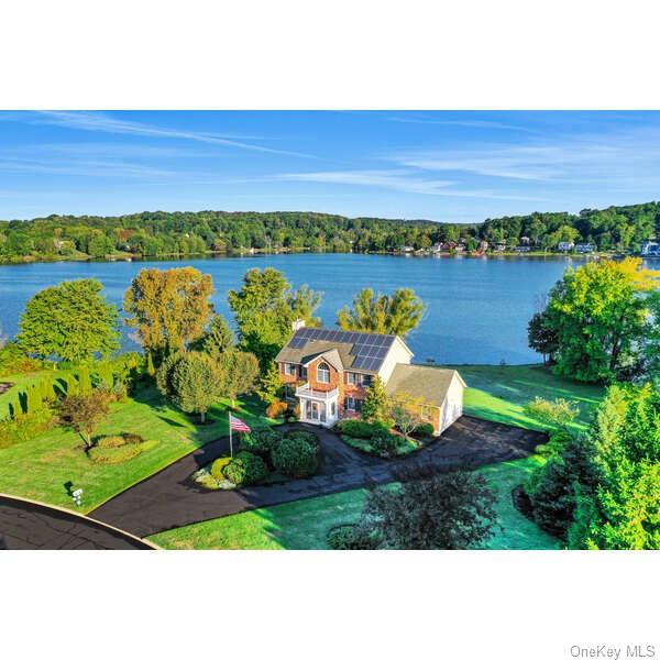 an aerial view of a house with a lake view