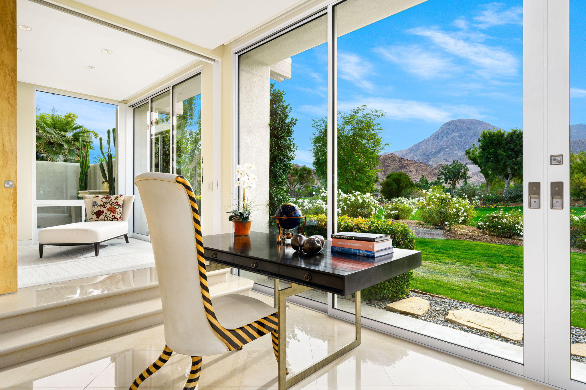 a dining room with furniture and floor to ceiling window