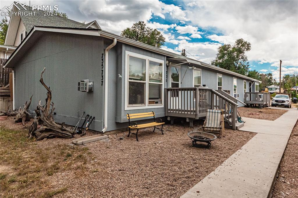 View of home's exterior featuring a deck and an outdoor fire pit