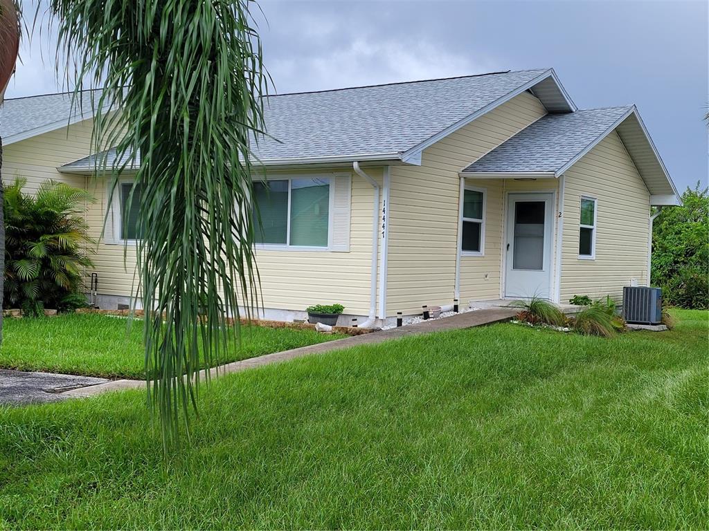 a front view of house with yard and green space