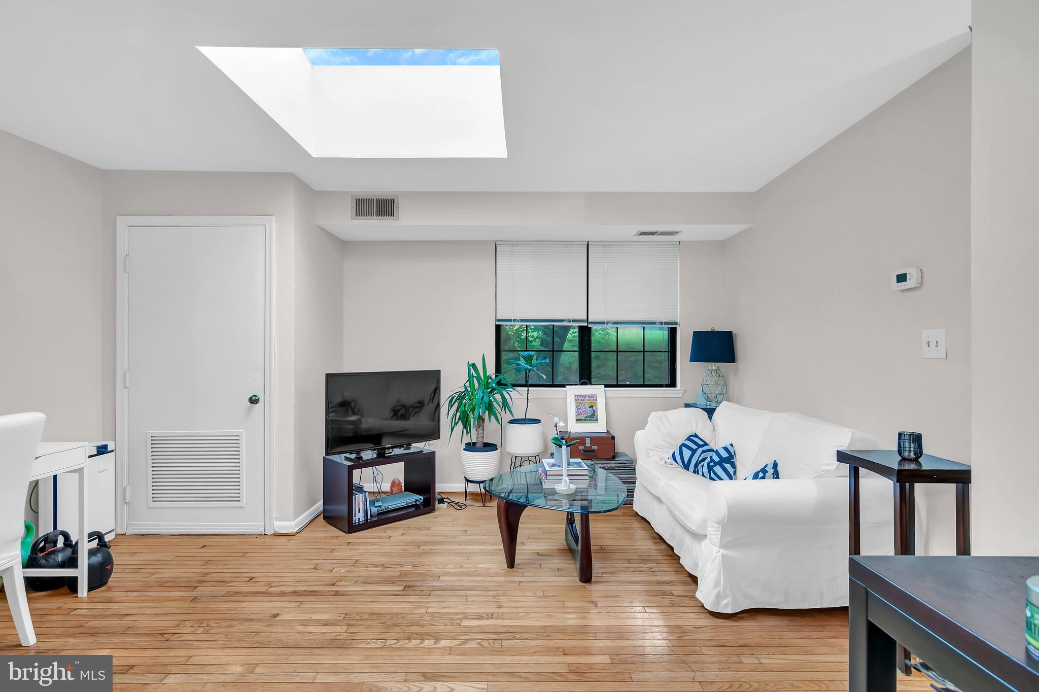 a living room with furniture fireplace and a large window